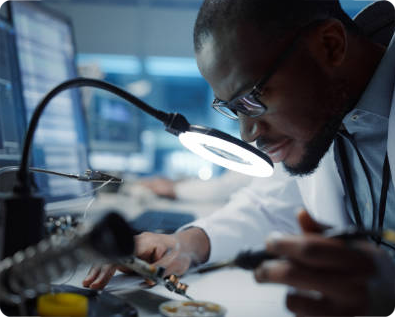 Biomedical technician performing precision repairs on equipment.